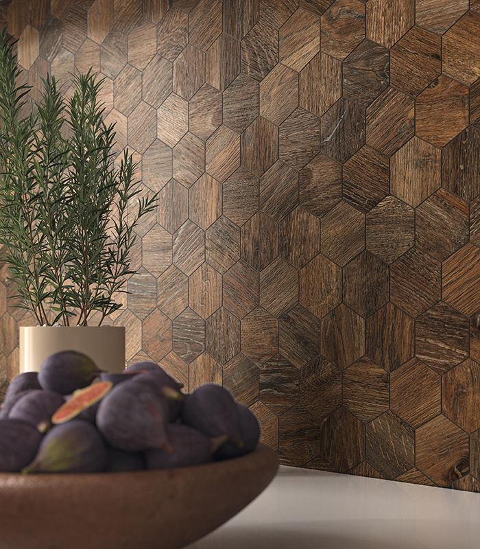 Close-up view of kitchen backsplash covered with dark wood-effect hexagonal porcelain stoneware mosaic tiles